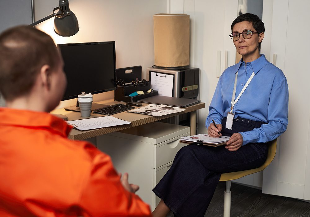 Therapist interviewing client across desk