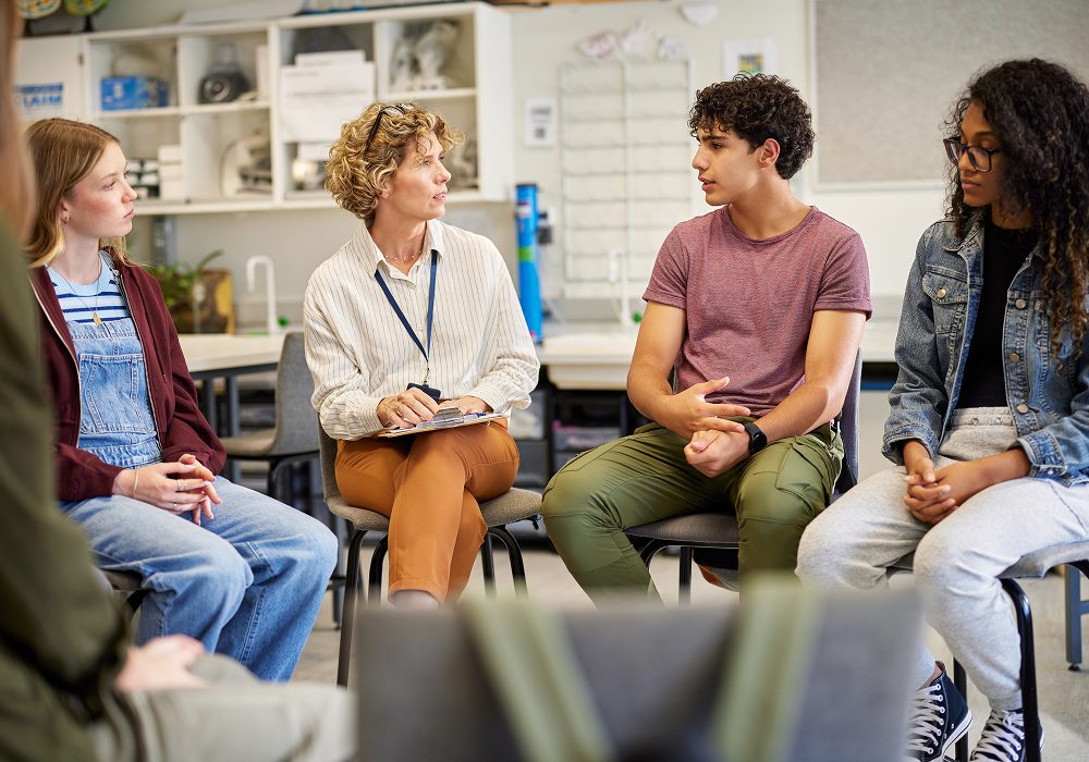 Teacher leading students in group discussion