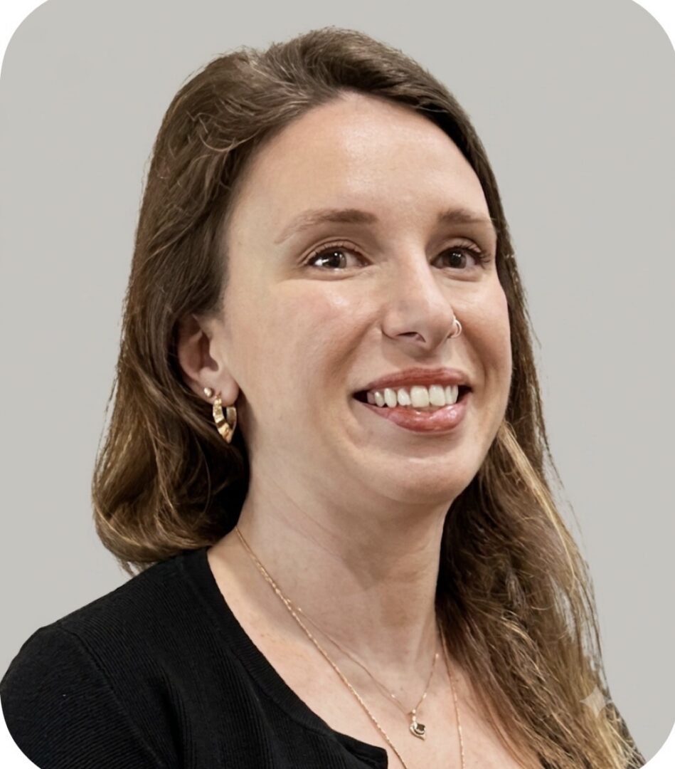 Smiling woman wearing gold earrings and necklace